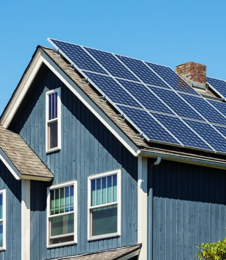 blue house with solar panel installation