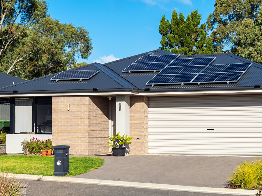 brick house with solar panels on black roof in Denver, CO